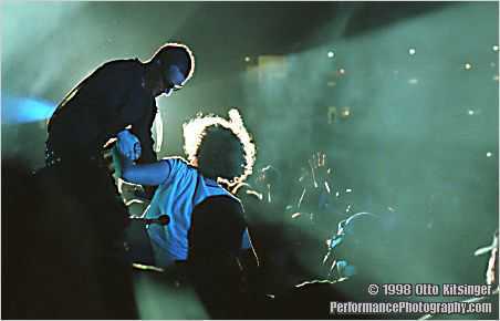 Live U2 concert photo of Bono and fan