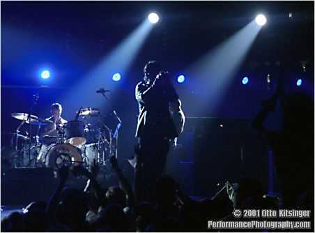 Live U2 concert photo of Larry Mullen Jr, Bono