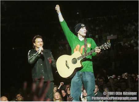 Live U2 concert photo of Bono and fan
