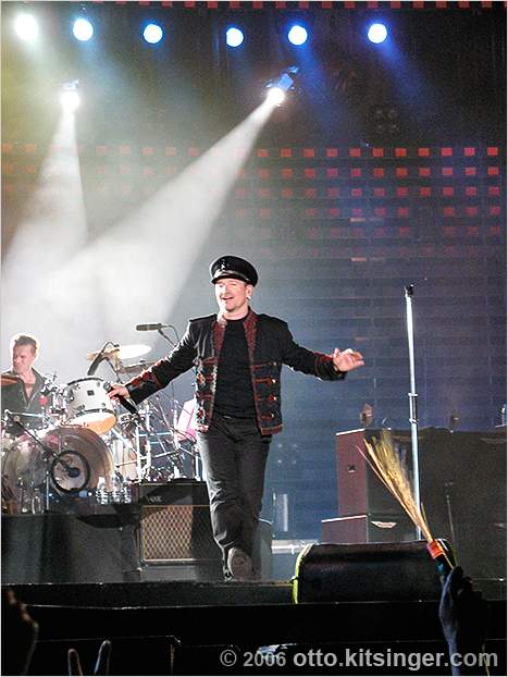Live concert photo of Bono, Larry Mullen Jr (bg)