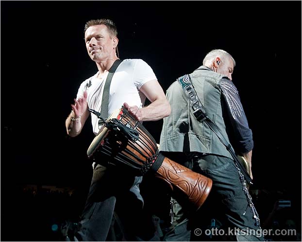 Live U2 concert photo of Larry Mullen Jr, Adam Clayton
