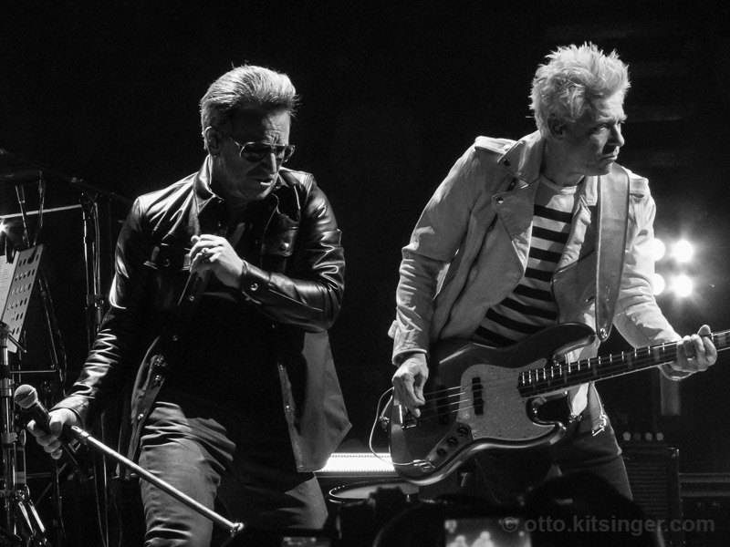 Live concert photo of Bono, Adam Clayton